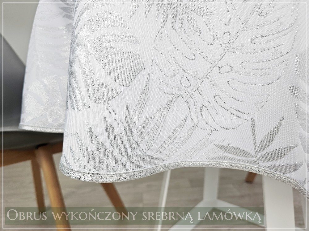 Obrus plamoodporny DE LUX MONSTERA SREBRNA wykończony srebrną lamówką